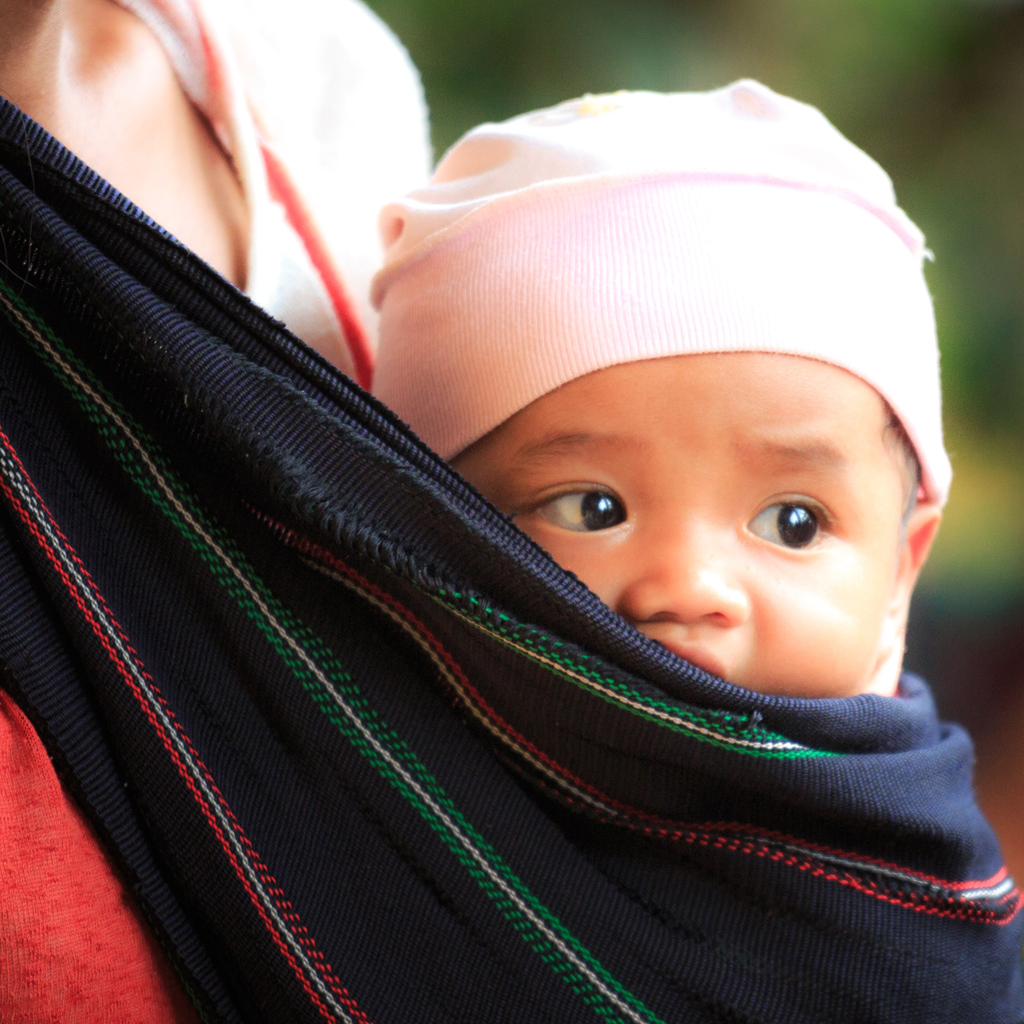 Baby being held in a wrap